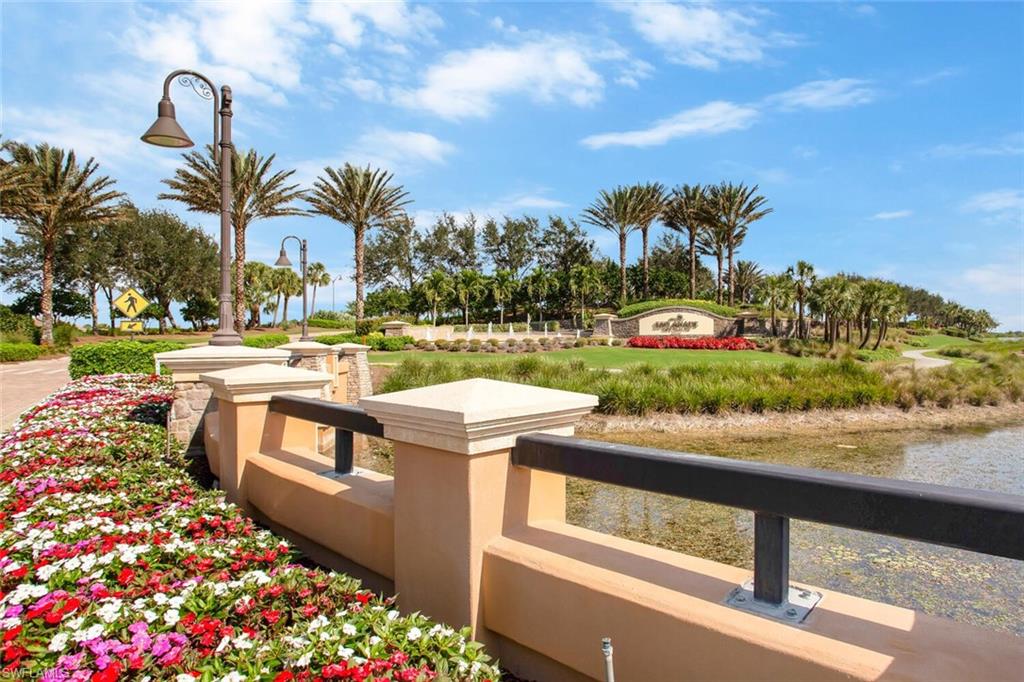 9650 Montelanico Loop, Unit 103 Naples, FL 34119 - Photo 26 of 29 a view of a yard with flower plants