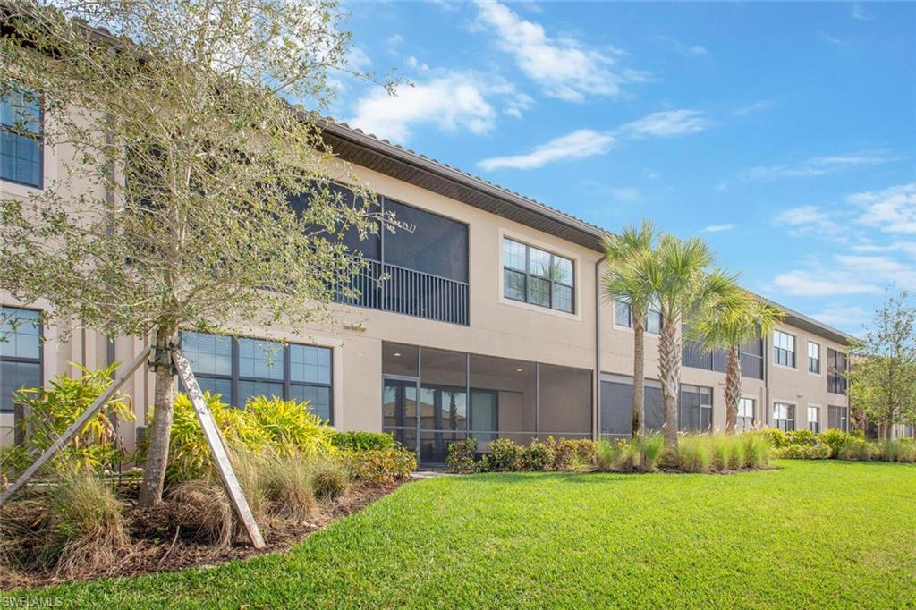 9650 Montelanico Loop, Unit 103 Naples, FL 34119 - Photo 29 of 29 a view of a building next to a yard