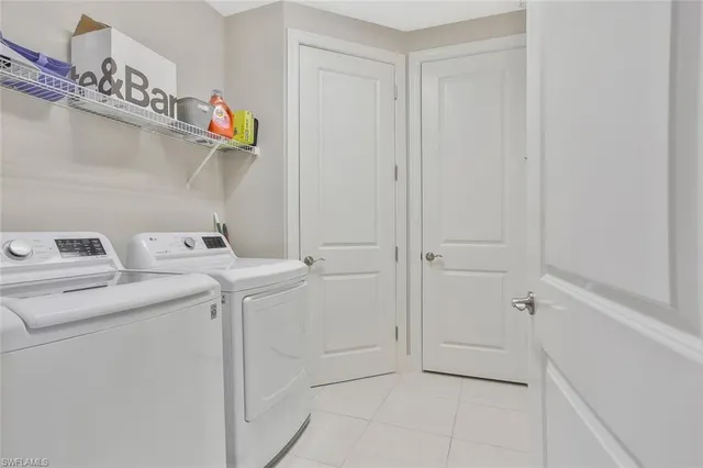 a kitchen with white cabinets and appliances