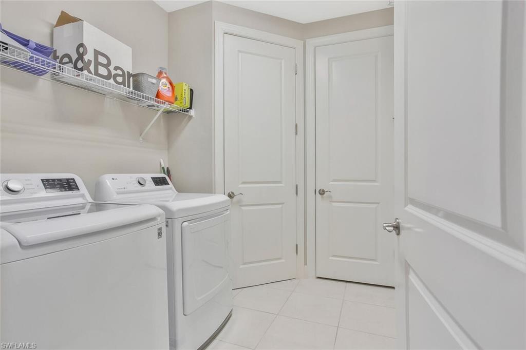 9650 Montelanico Loop, Unit 103 Naples, FL 34119 - Photo 4 of 29 a utility room with dryer and washer