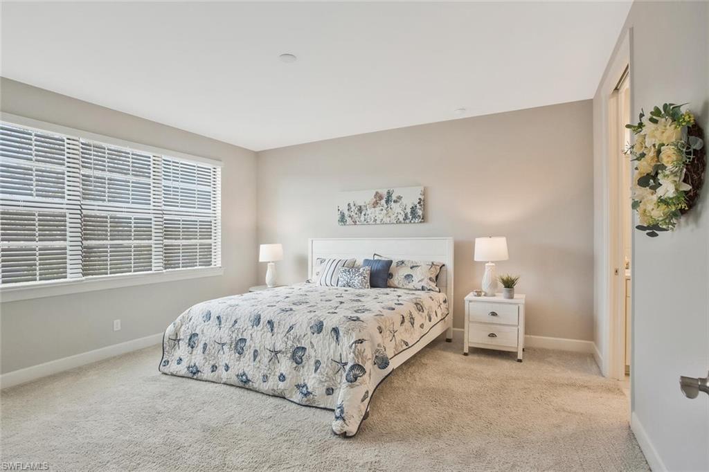 9650 Montelanico Loop, Unit 103 Naples, FL 34119 - Photo 9 of 29 a bedroom with a bed and a window