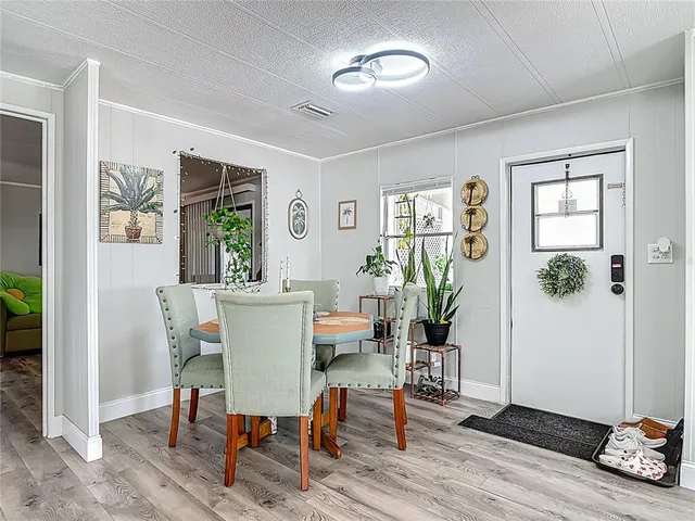 a view of a dining room with furniture window and wooden floor