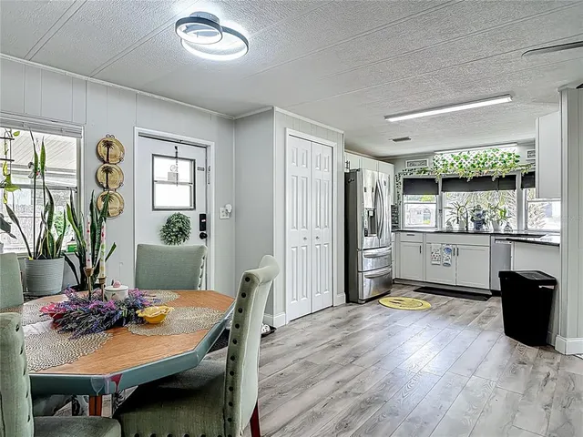 a view of a dining room with furniture and wooden floor