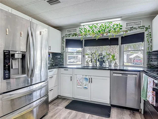 a kitchen with stainless steel appliances granite countertop a stove and a microwave