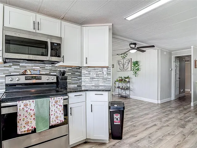 a kitchen with stainless steel appliances a refrigerator and cabinets