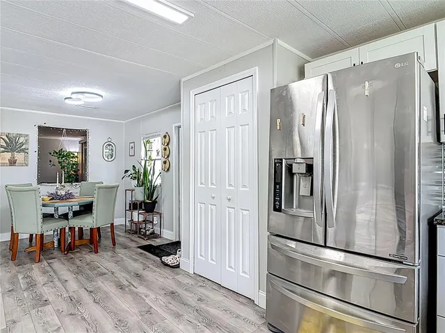 a kitchen with a sink a counter top space stainless steel appliances and a window