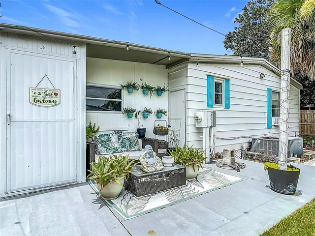 a view of a patio with table and chairs and potted plants