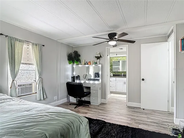 a bathroom with a granite countertop toilet sink and mirror