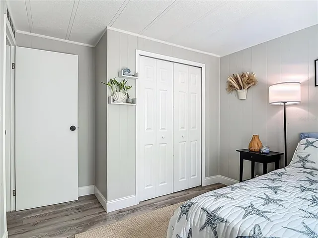 a bathroom with a granite countertop sink vanity mirror bathtub and toilet