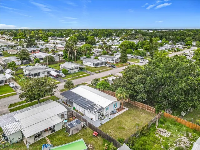 an aerial view of residential houses with outdoor space and street view