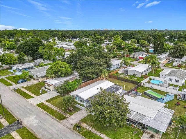 an aerial view of residential houses with outdoor space and street view