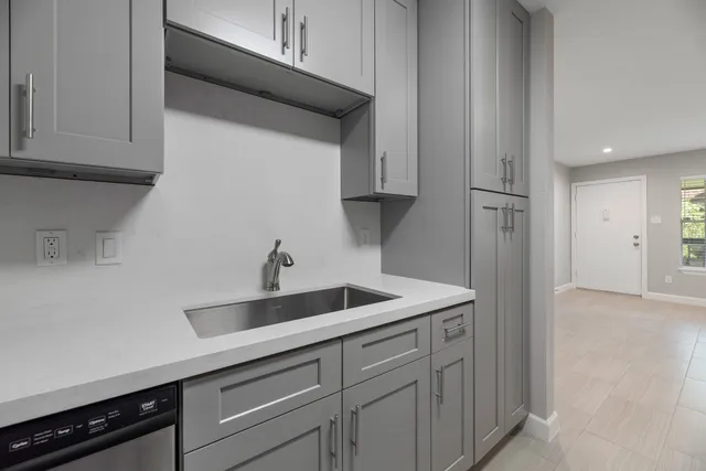 a kitchen with a sink and cabinets