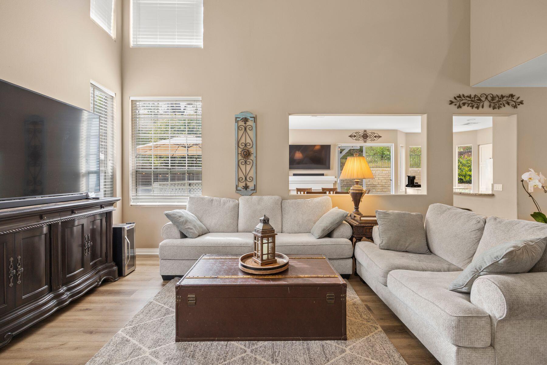 697 Buenos Tiempos Drive Camarillo, CA 93012 - Photo 11 of 29 a living room with furniture a flat screen tv and a large window