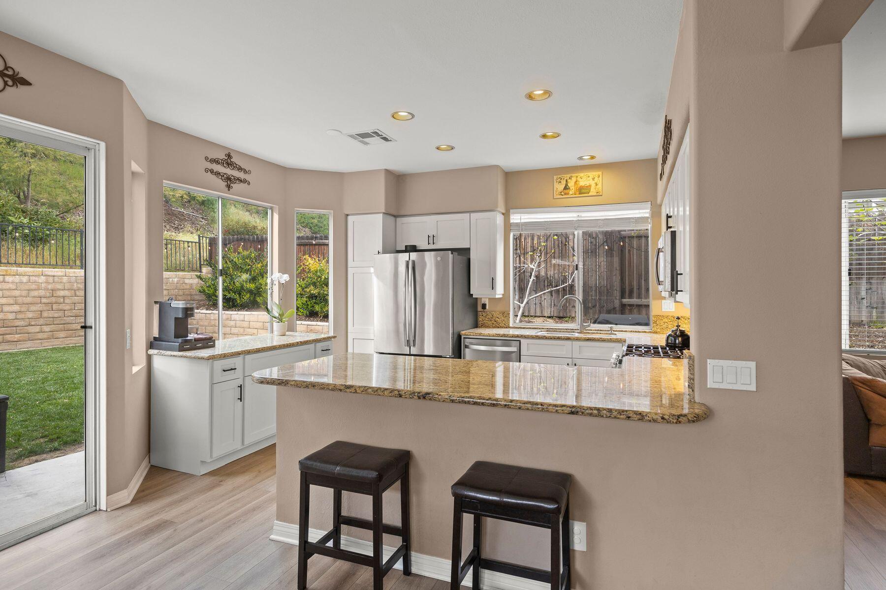 697 Buenos Tiempos Drive Camarillo, CA 93012 - Photo 12 of 29 a kitchen with stainless steel appliances granite countertop a stove and a refrigerator