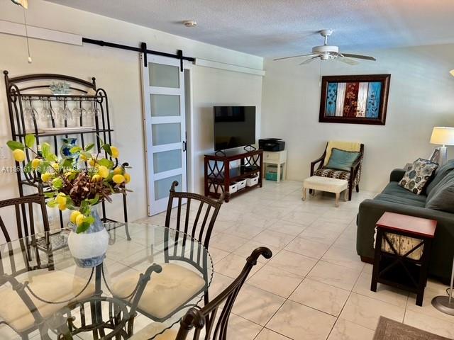 3212 Northeast 8th Court, Unit 12 Pompano Beach, FL 33062 - Photo 1 of 17 a living room with furniture and a flat screen tv