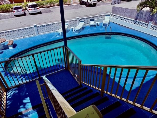 3212 Northeast 8th Court, Unit 12 Pompano Beach, FL 33062 - Photo 12 of 17 a balcony with hardwood wall