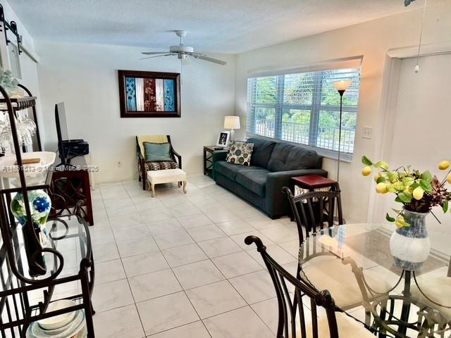 3212 Northeast 8th Court, Unit 12 Pompano Beach, FL 33062 - Photo 2 of 17 a living room with furniture a flat screen tv and a window