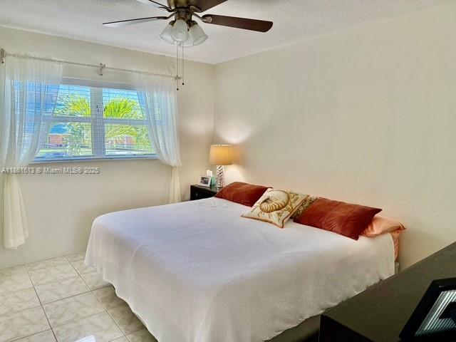 3212 Northeast 8th Court, Unit 12 Pompano Beach, FL 33062 - Photo 4 of 17 a bedroom with a bed and window