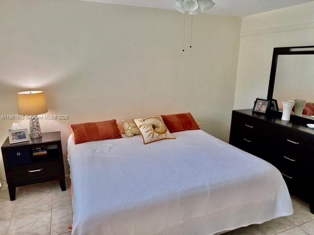 3212 Northeast 8th Court, Unit 12 Pompano Beach, FL 33062 - Photo 5 of 17 a bedroom with a bed and a dresser