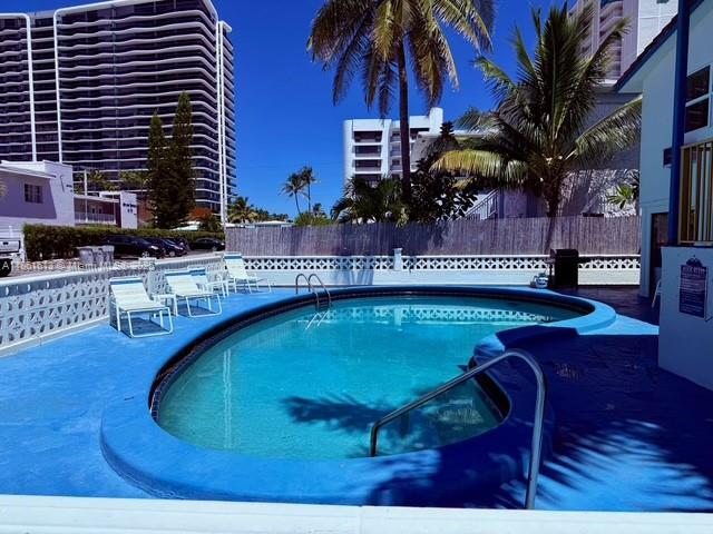 3212 Northeast 8th Court, Unit 12 Pompano Beach, FL 33062 - Photo 8 of 17 a swimming pool with outdoor seating and yard