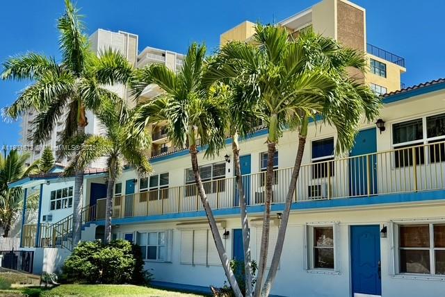 3212 Northeast 8th Court, Unit 12 Pompano Beach, FL 33062 - Photo 10 of 17 a front view of a house with a garden