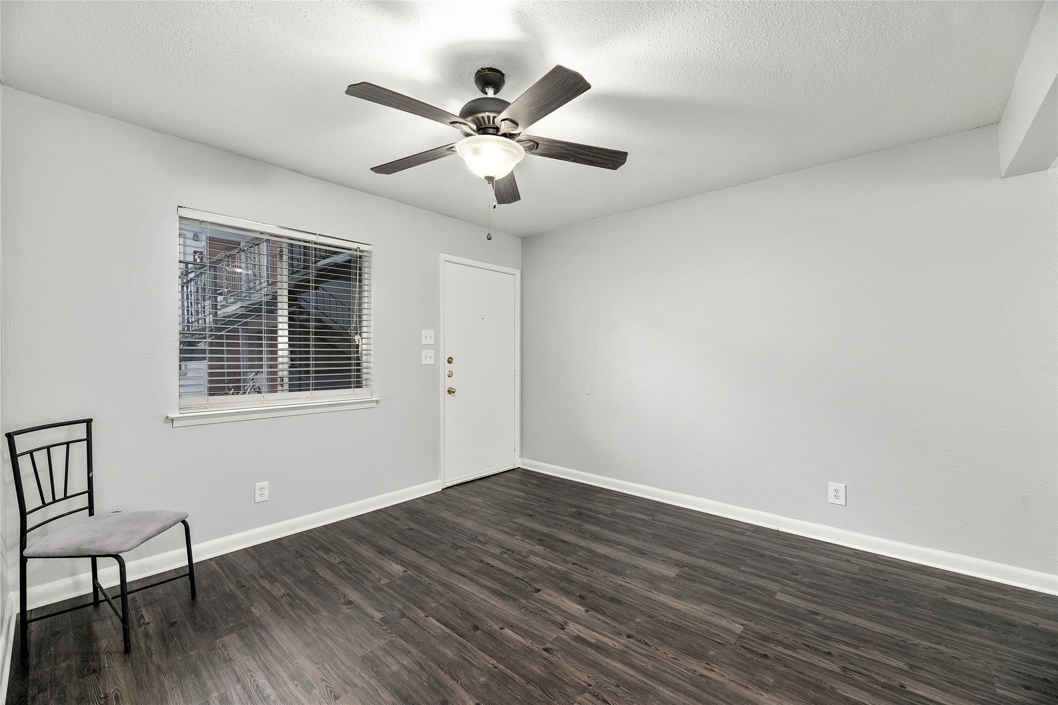 2408 Longview Street, Unit 113 Austin, TX 78705 - Photo 3 of 23 Entryway featuring dark wood-style flooring, a ceiling fan, and a textured ceiling