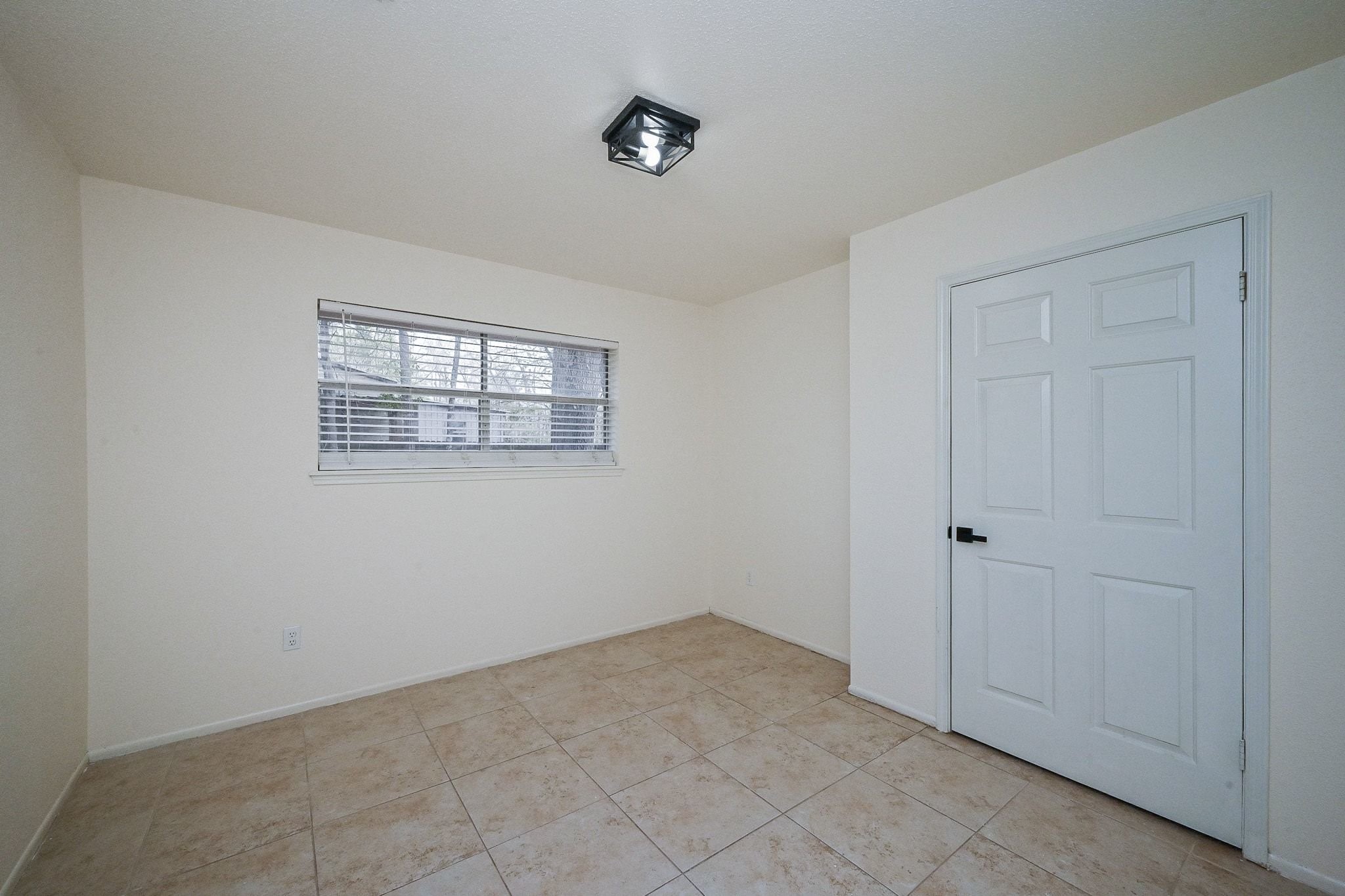 17831 Magnolia Lane New Caney, TX 77357 - Photo 11 of 27 Step into this amazing second bedroom! Notice the beautiful and unique light fixture that really compliments the room. Beautiful tile flooring add to the neutral-tone of this room, making your decoration necessities easy! The huge closet door allows ample storage space. This room is truly perfect for a versatile space or for children to enjoy!
