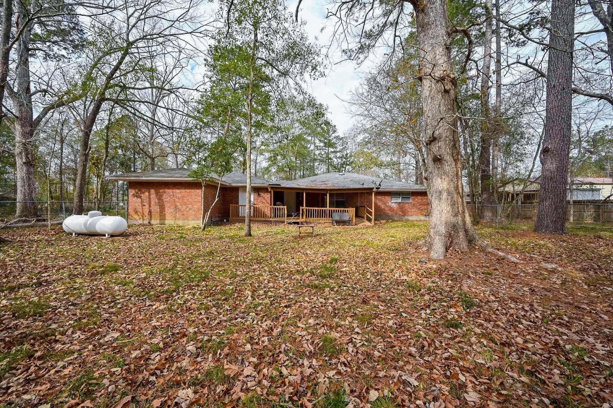 17831 Magnolia Lane New Caney, TX 77357 - Photo 20 of 27 This huge yard is covered in plush green grass and mature trees for ample shading! The fully fenced yard ensures a sense of privacy for all around relaxation with your family.