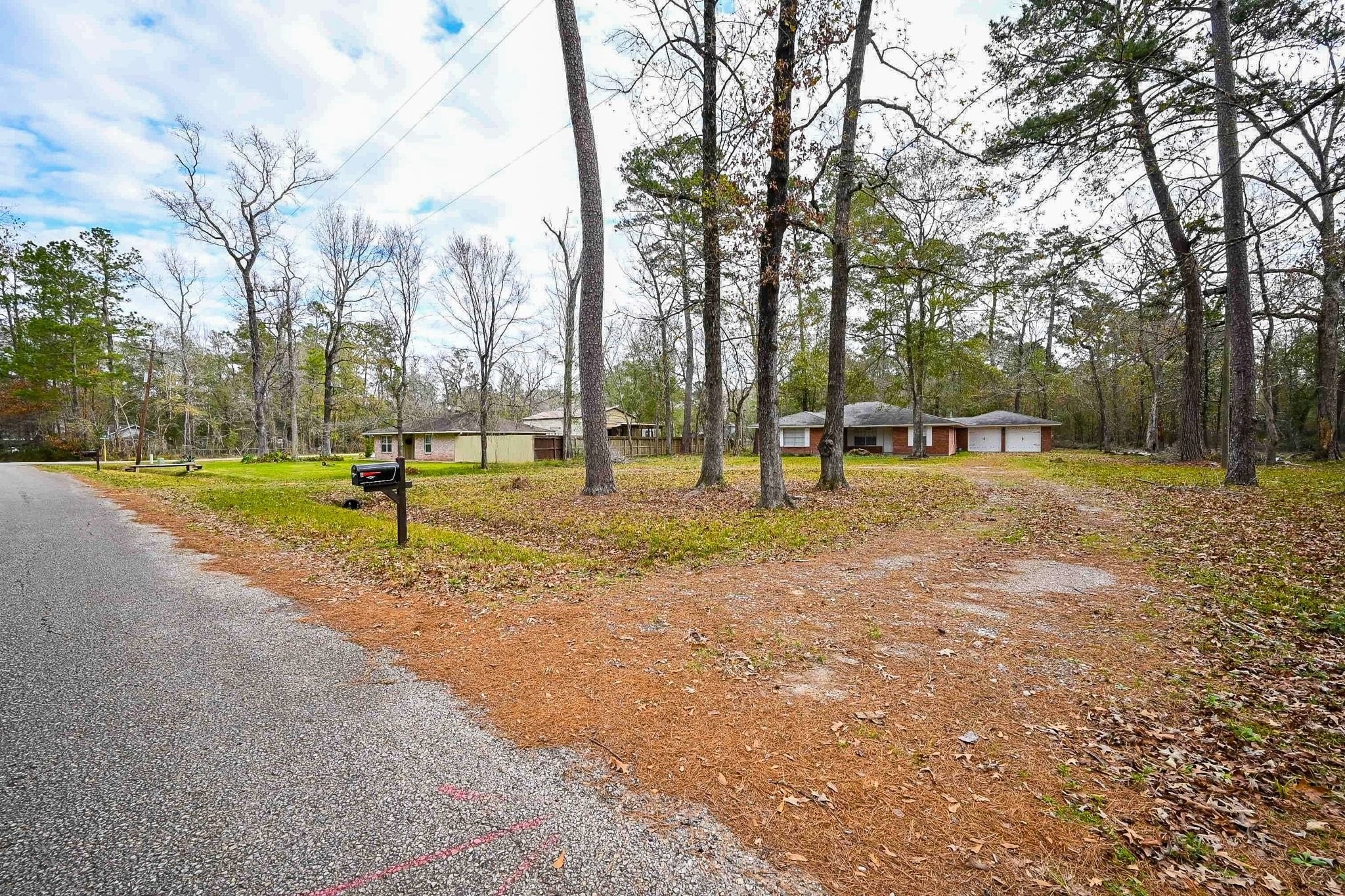 17831 Magnolia Lane New Caney, TX 77357 - Photo 2 of 27 Take a look at this long, spacious driveway that leads to this gorgeous home. You can really see how much land you acquire with a massive front yard!