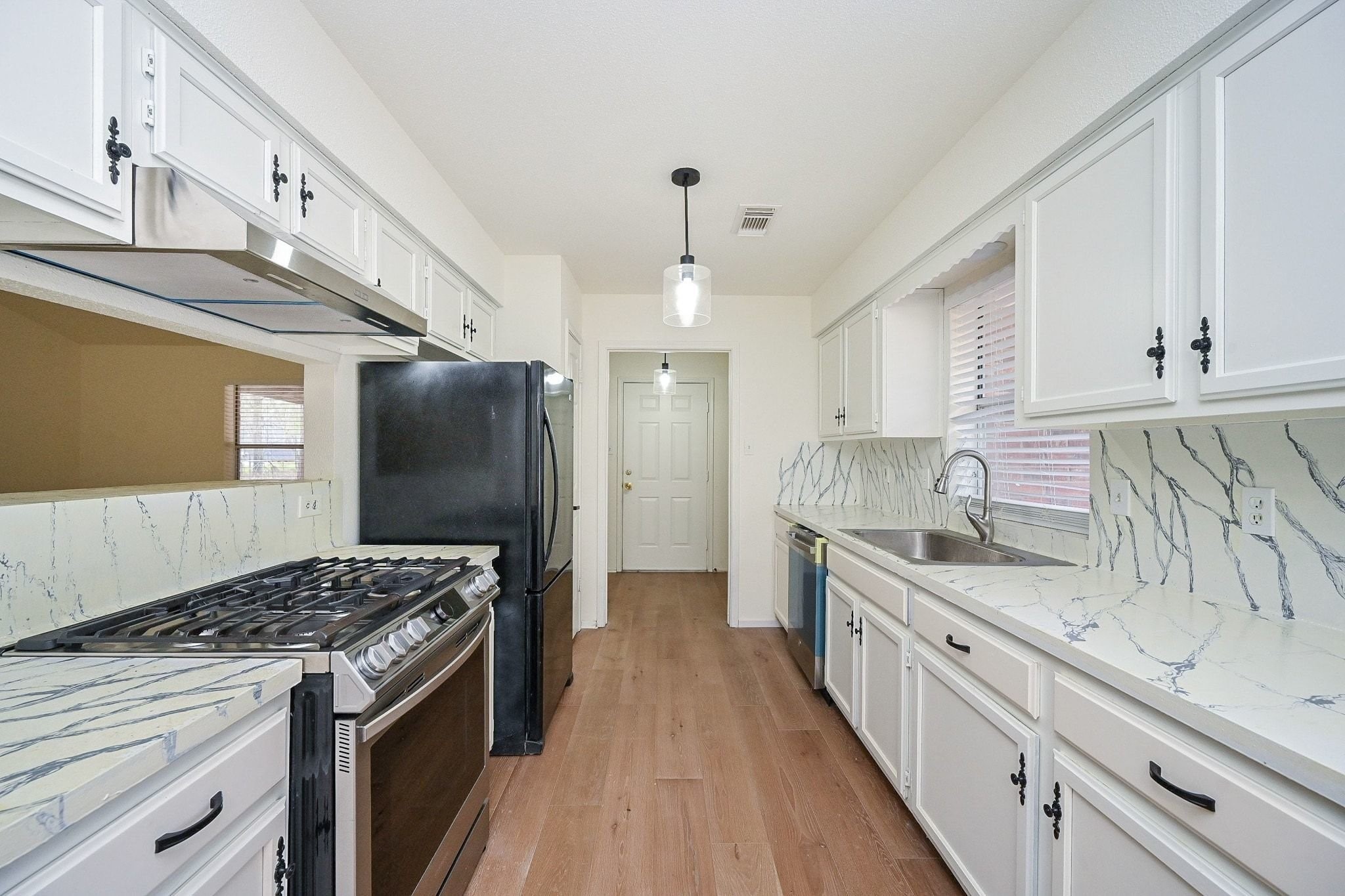 17831 Magnolia Lane New Caney, TX 77357 - Photo 6 of 27 Welcome to this well-appointed kitchen! The beautiful backsplash compliments the huge countertops that are perfect for meal preparation, and crisp, white cabinetry that offers plenty of storage space!