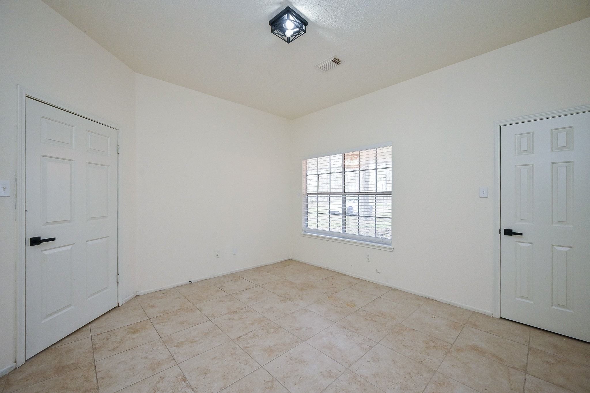 17831 Magnolia Lane New Caney, TX 77357 - Photo 10 of 27 Welcome to the first bedroom! This room has huge windows that allow ample natural light to stream into the room, creating a bright and airy feel! A huge closet door ensures a roomy closet to allow plenty of storage space!