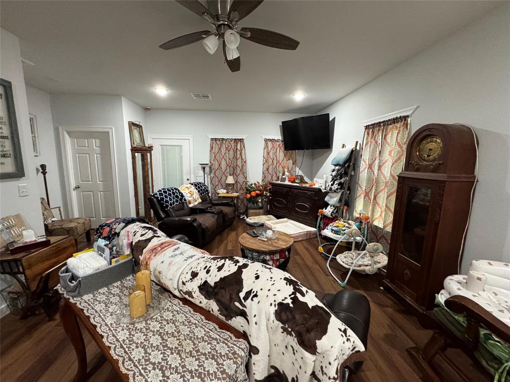 1307 West 33rd Street Tyler, TX 75702 - Photo 2 of 5 a living room with furniture and a flat screen tv