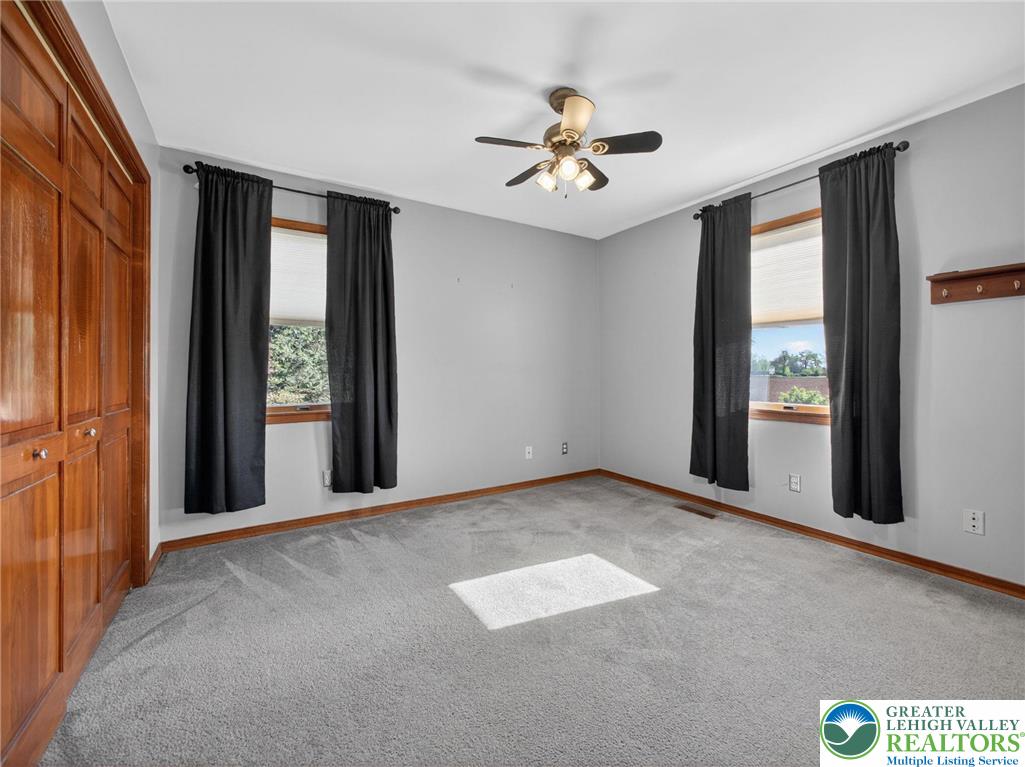 7098 Limerick Square Bath, PA 18014 - Photo 19 of 31 an empty room with windows and chandelier fan