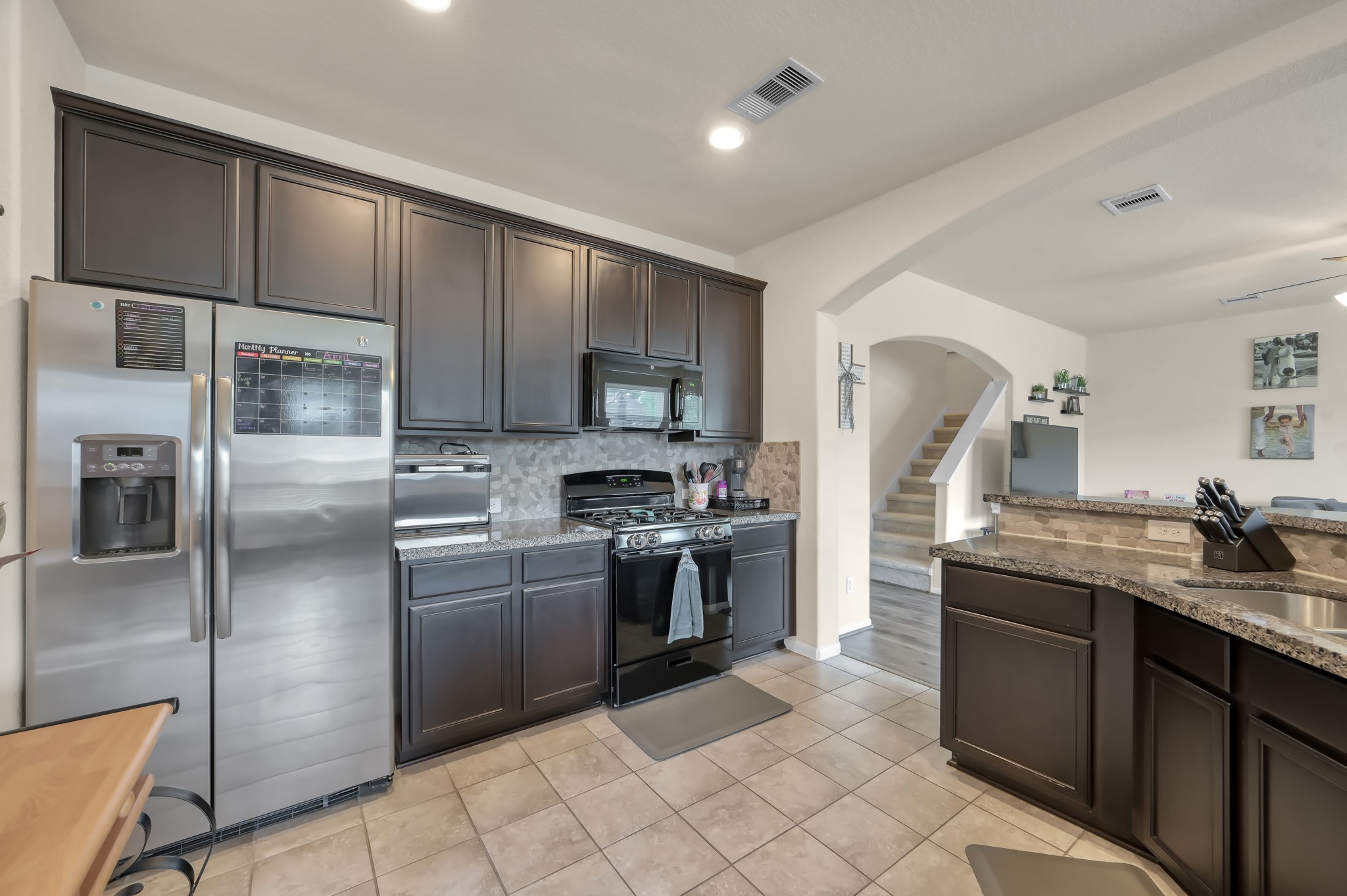 21550 Rainfall Park Drive Spring, TX 77388 - Photo 11 of 38 a kitchen with stainless steel appliances granite countertop a refrigerator a stove and a sink