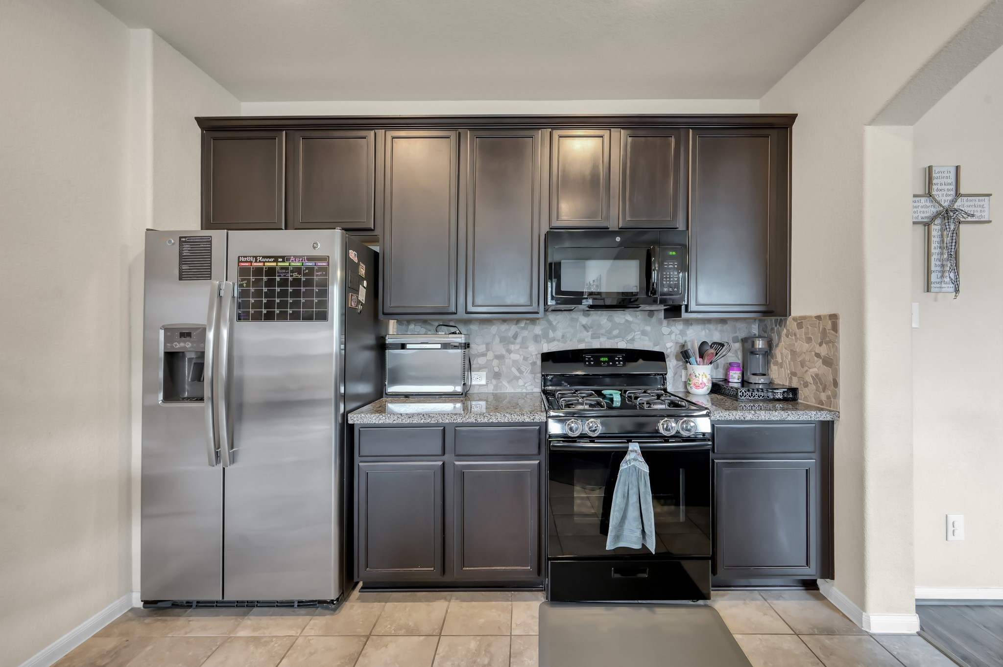 21550 Rainfall Park Drive Spring, TX 77388 - Photo 12 of 38 a kitchen with stainless steel appliances granite countertop a stove and a refrigerator