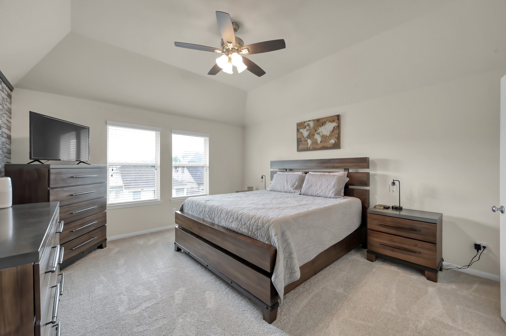 21550 Rainfall Park Drive Spring, TX 77388 - Photo 15 of 38 a spacious bedroom with a bed and a chandelier