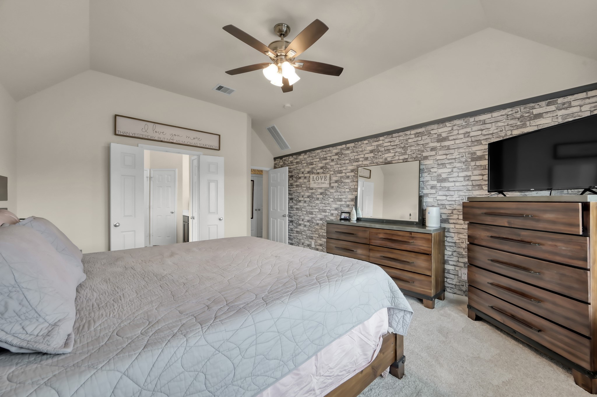 21550 Rainfall Park Drive Spring, TX 77388 - Photo 16 of 38 a bedroom with a bed and a flat screen tv