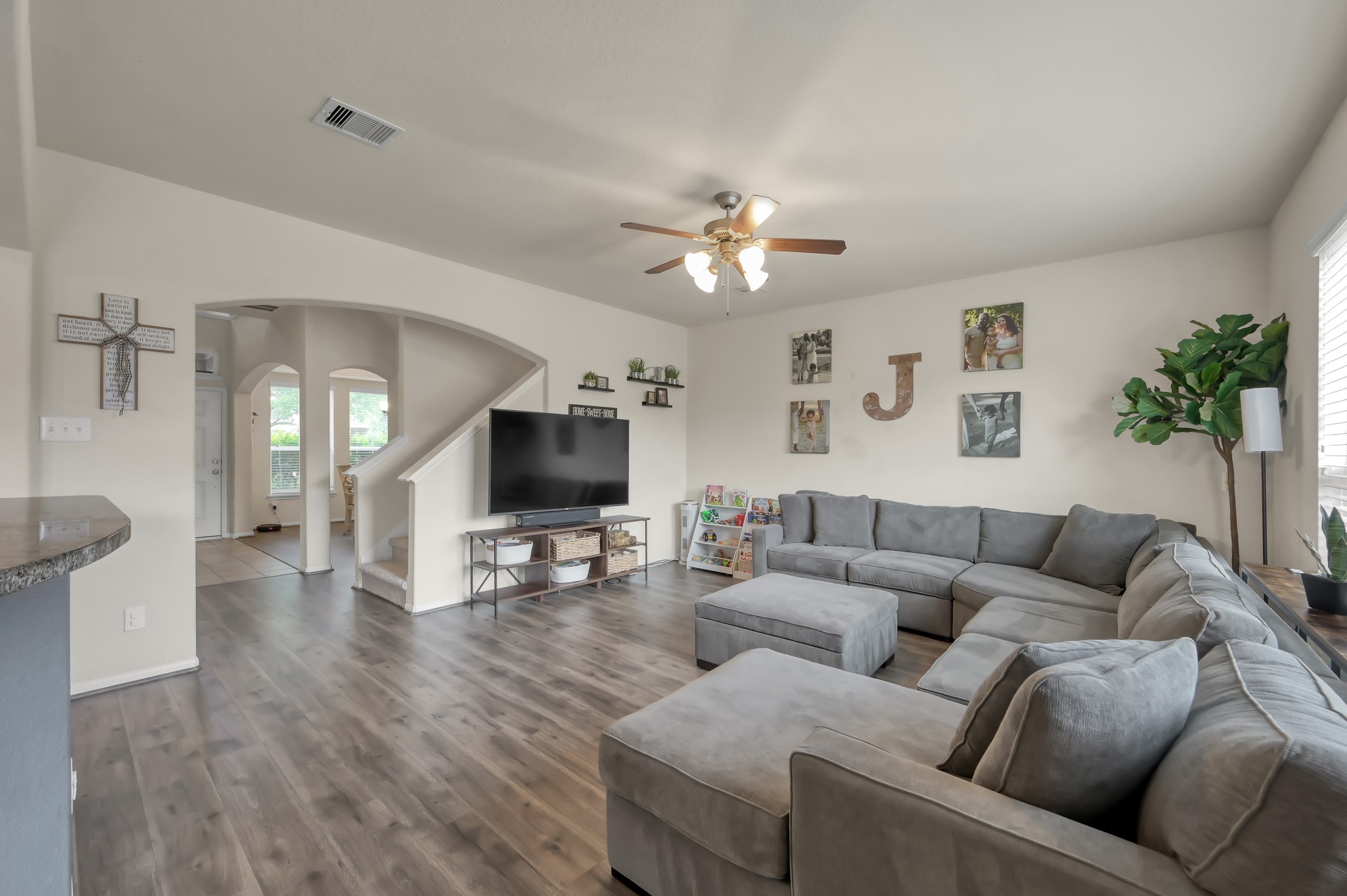 21550 Rainfall Park Drive Spring, TX 77388 - Photo 8 of 38 a living room with furniture flat screen tv and wooden floor