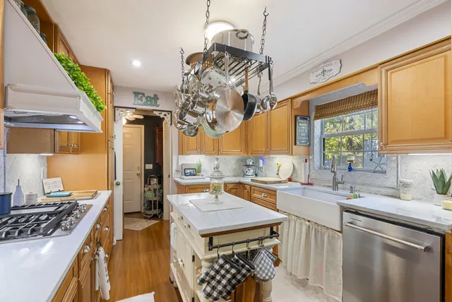 a kitchen with a sink a stove and a wooden floors
