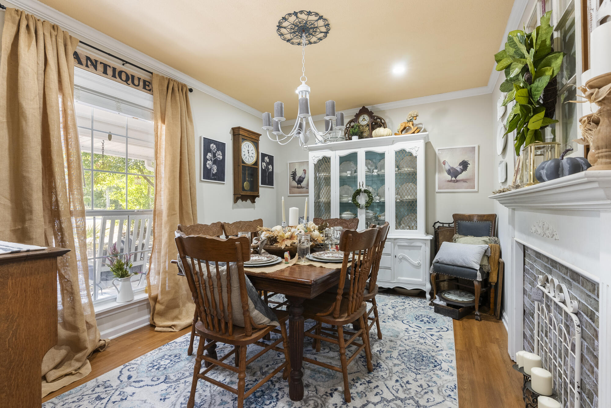 902 Northwest Ave D Carrabelle, FL 32322 - Photo 15 of 32 a view of a dining room with furniture a chandelier and wooden floor