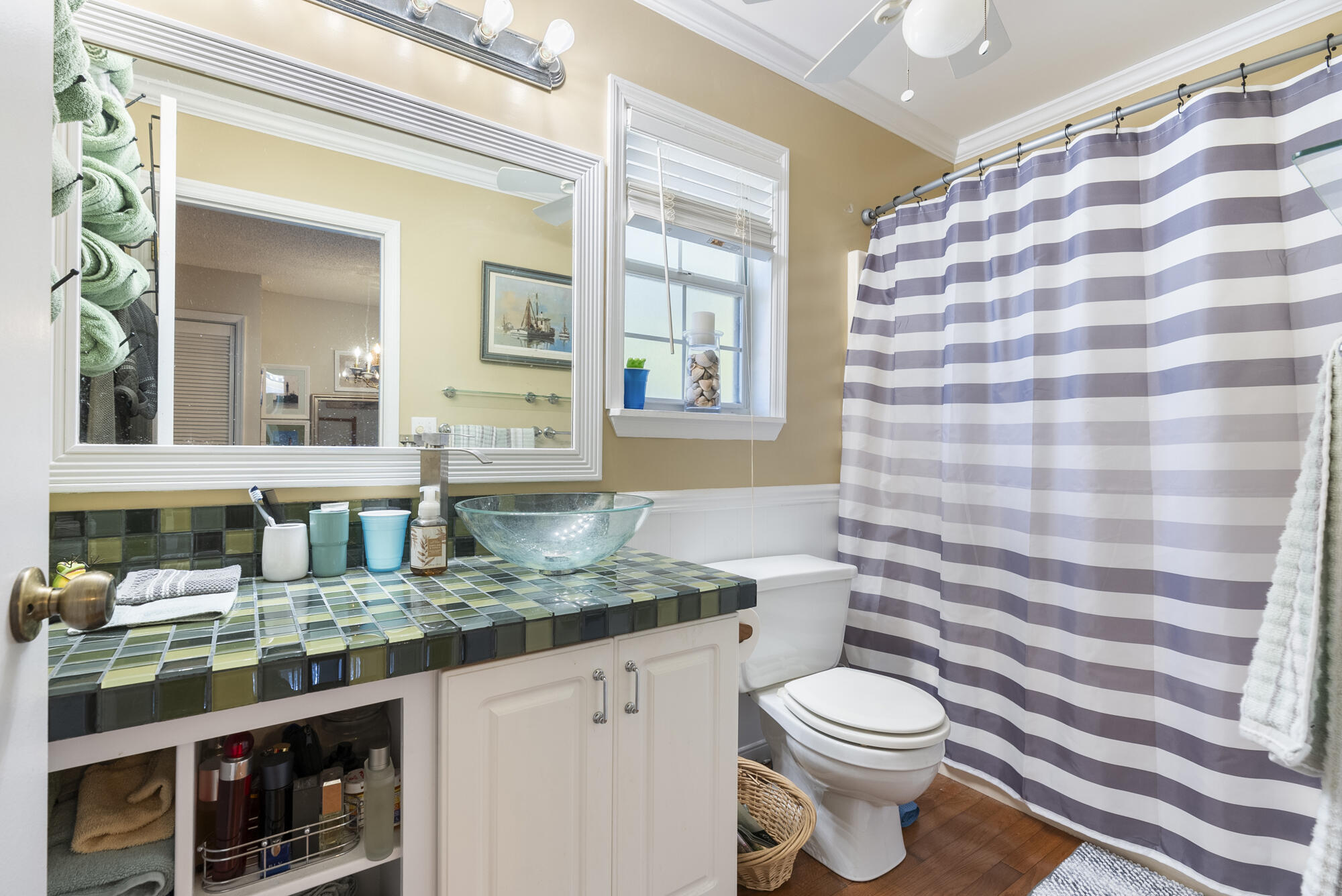 902 Northwest Ave D Carrabelle, FL 32322 - Photo 20 of 32 a bathroom with a granite countertop sink mirror vanity and toilet