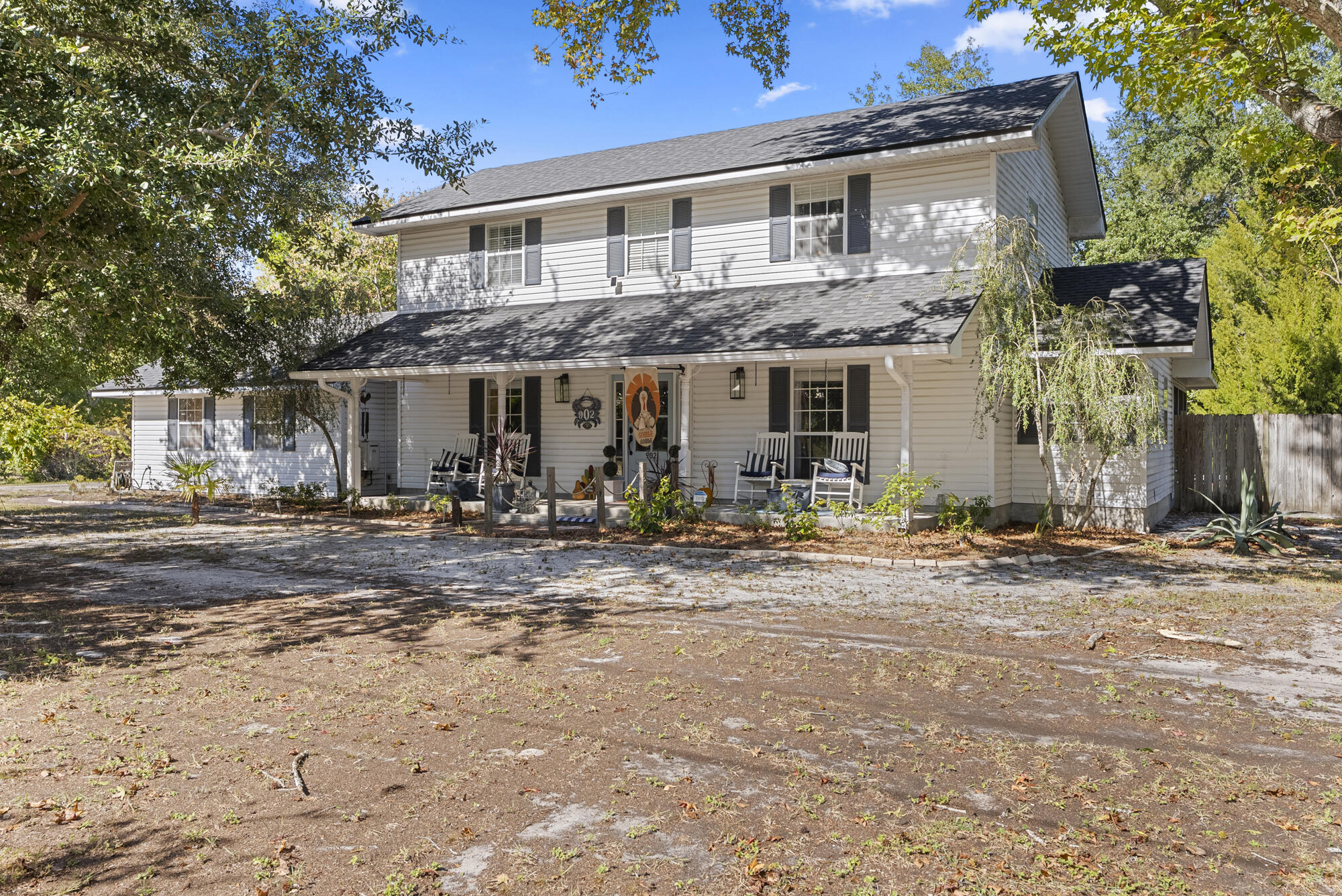 902 Northwest Ave D Carrabelle, FL 32322 - Photo 2 of 32 a front view of a house with garden