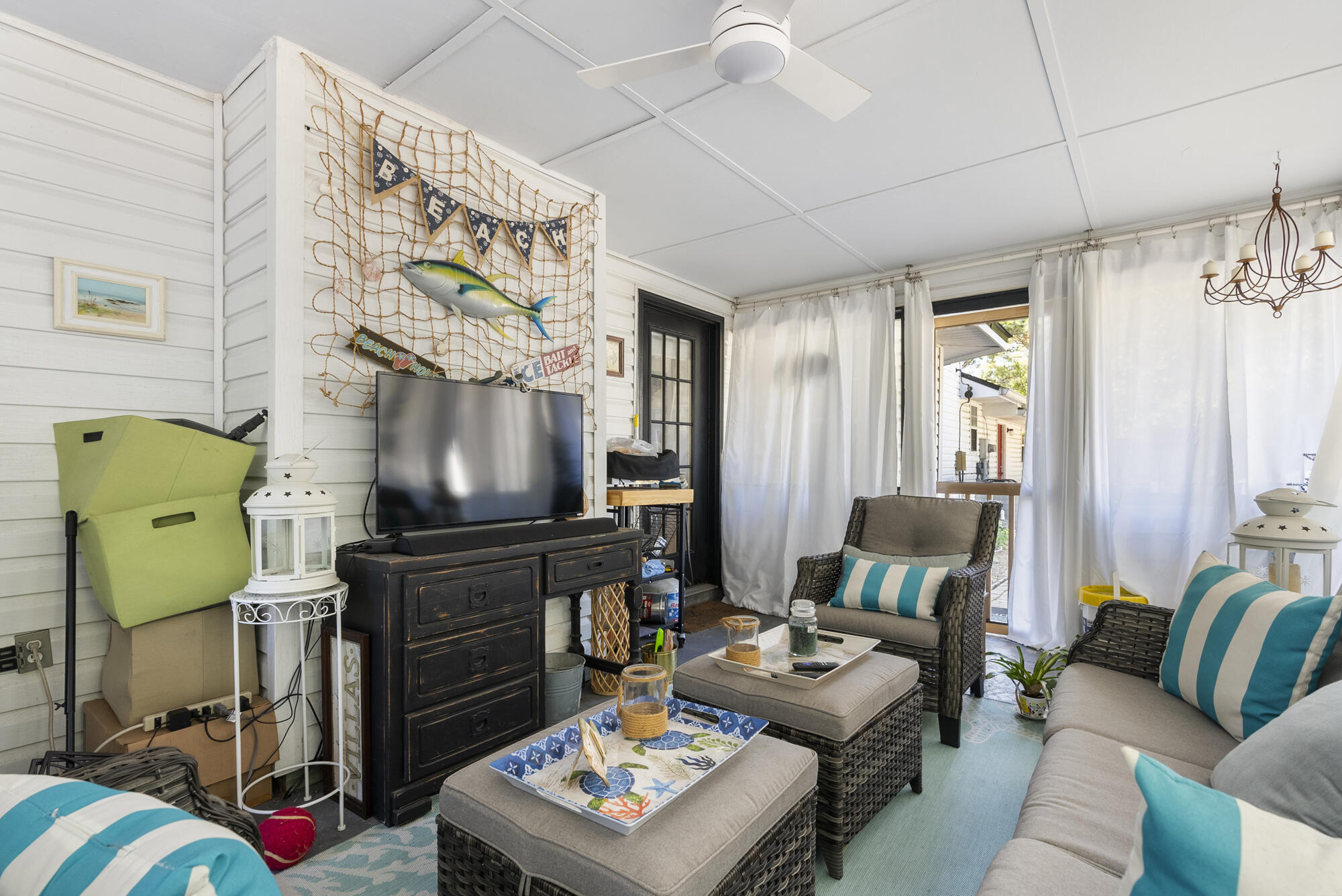 902 Northwest Ave D Carrabelle, FL 32322 - Photo 23 of 32 a living room with furniture and a flat screen tv