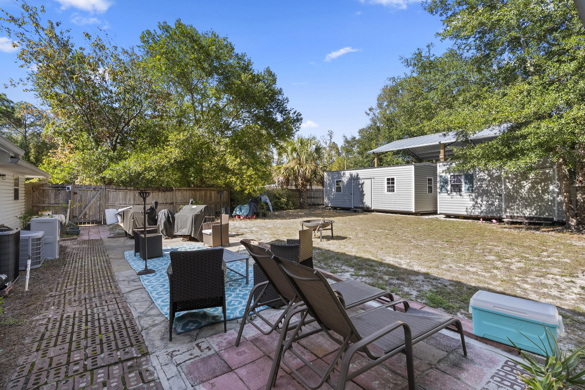 902 Northwest Ave D Carrabelle, FL 32322 - Photo 24 of 32 a backyard of a house with barbeque oven table and chairs