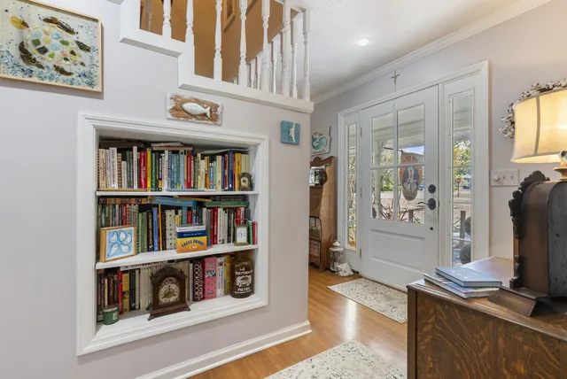 a book shelf with books and knick knacks on kitchen