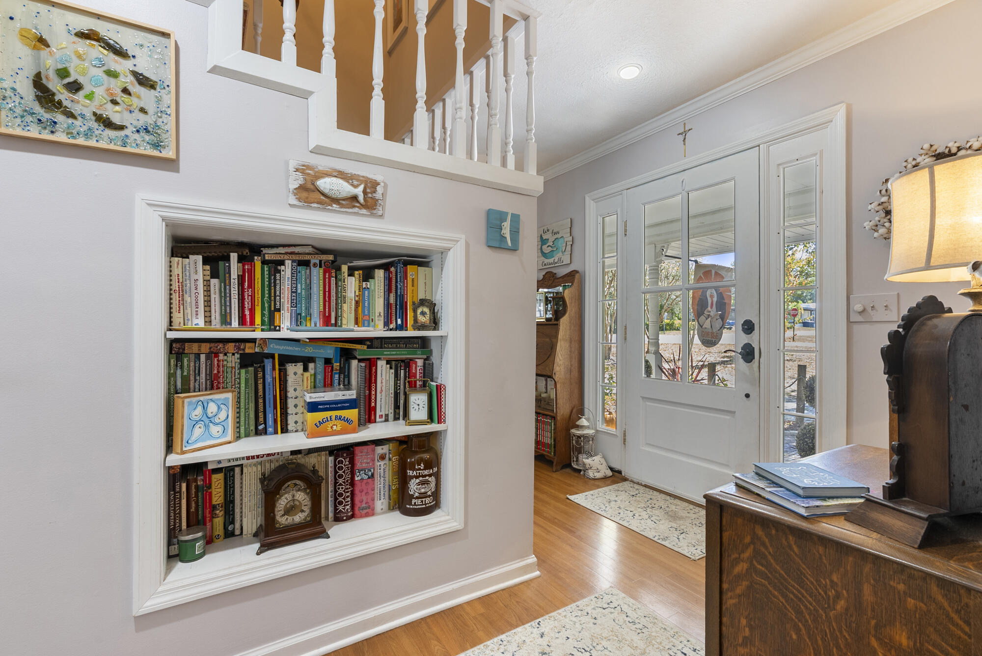 902 Northwest Ave D Carrabelle, FL 32322 - Photo 4 of 32 a book shelf with books and knick knacks on kitchen