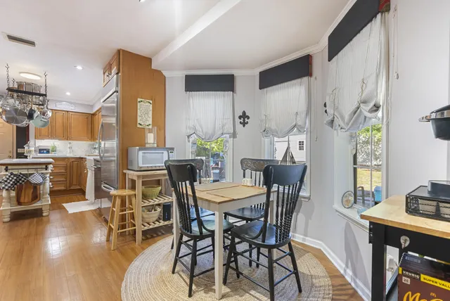 a view of a dining room with furniture and wooden floor