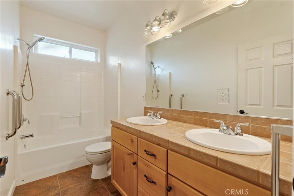 76846 Ranchita Canyon Road San Miguel, CA 93451 - Photo 16 of 51 a bathroom with a granite countertop sink toilet a mirror and shower