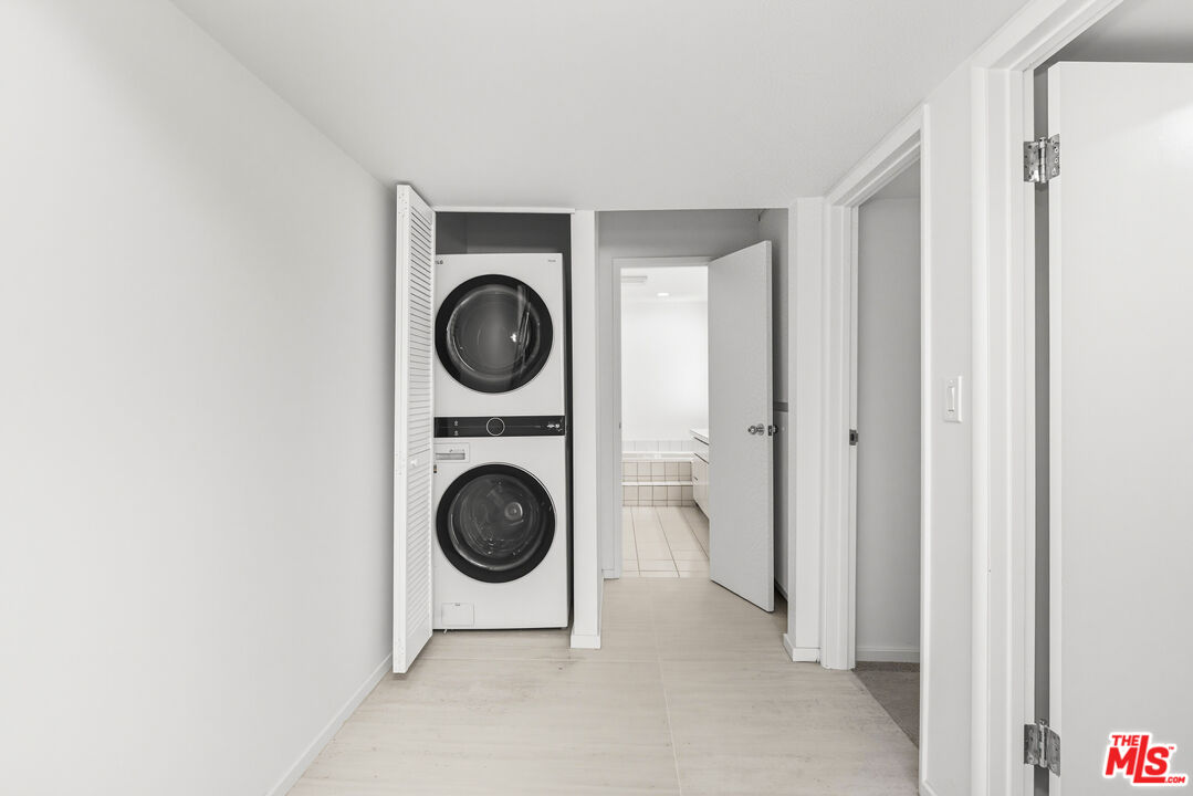 1591 Lindacrest Drive Beverly Hills, CA 90210 - Photo 13 of 17 a view of a hallway with washer and dryer