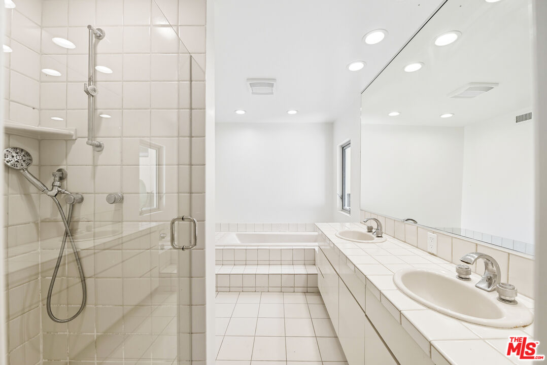 1591 Lindacrest Drive Beverly Hills, CA 90210 - Photo 14 of 17 a bathroom with a granite countertop sink a toilet and a shower